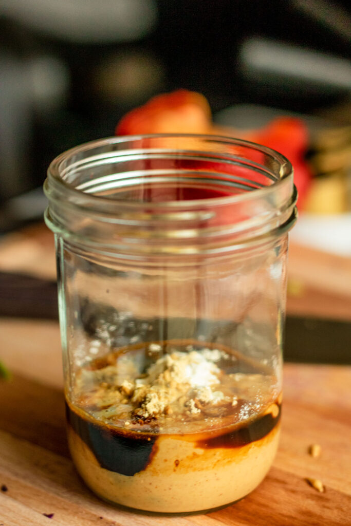 All the peanut sauce ingredients in a jar ready to be mixed.