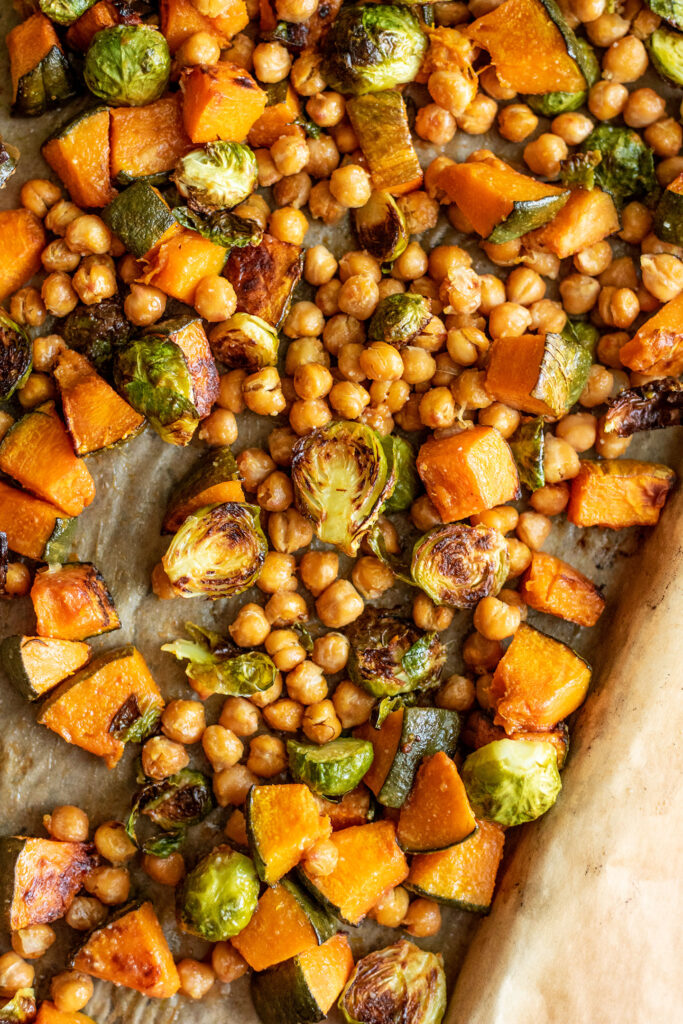 Sheet pan of roasted brussels sprouts, squash and chickpeas right out of the oven.