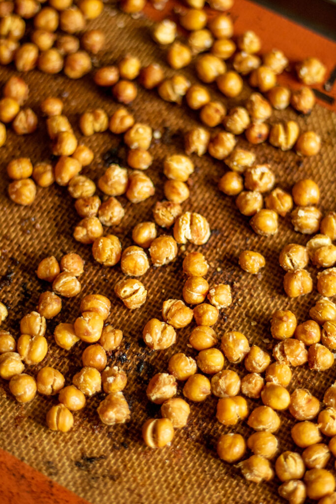 Roasted chickpeas on a baking tray.