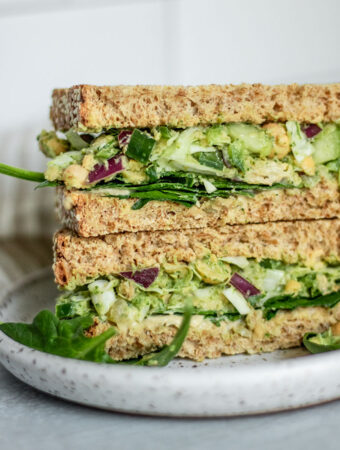 Sandwich stuffed with green goddess salad, spinach and hummus.