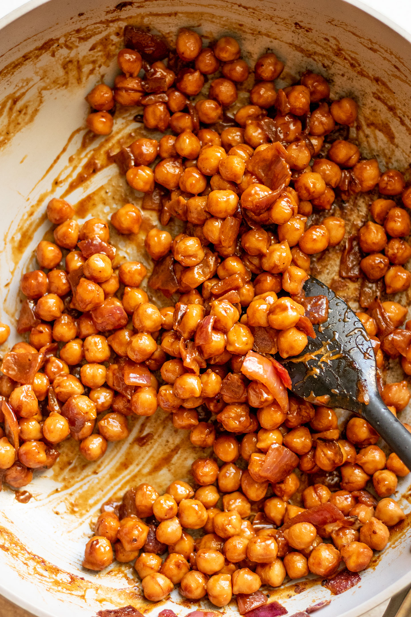 Sauteing chickpeas in barbecue sauce.