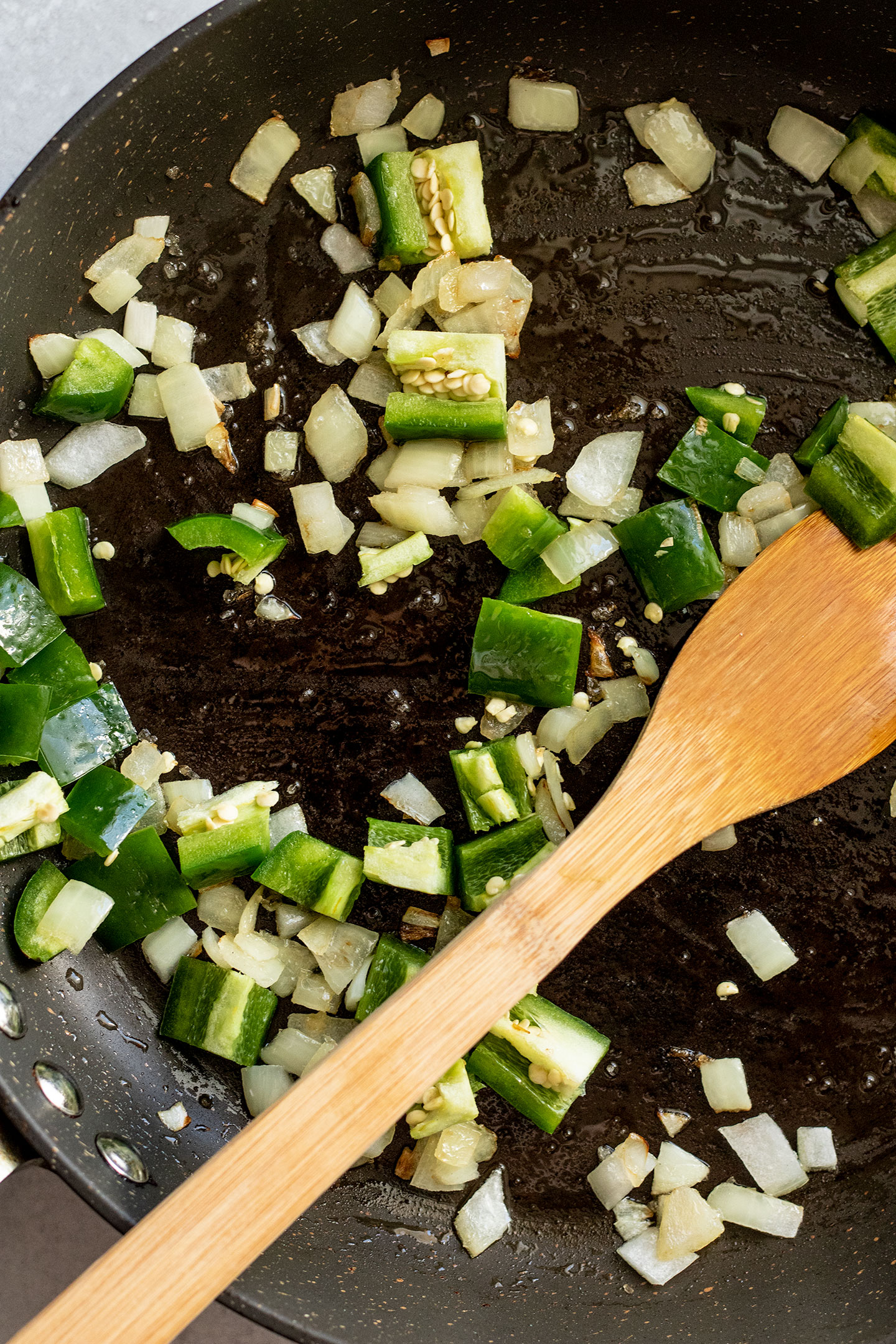 Sauteing onions, jalapeno and garlic in a pan.