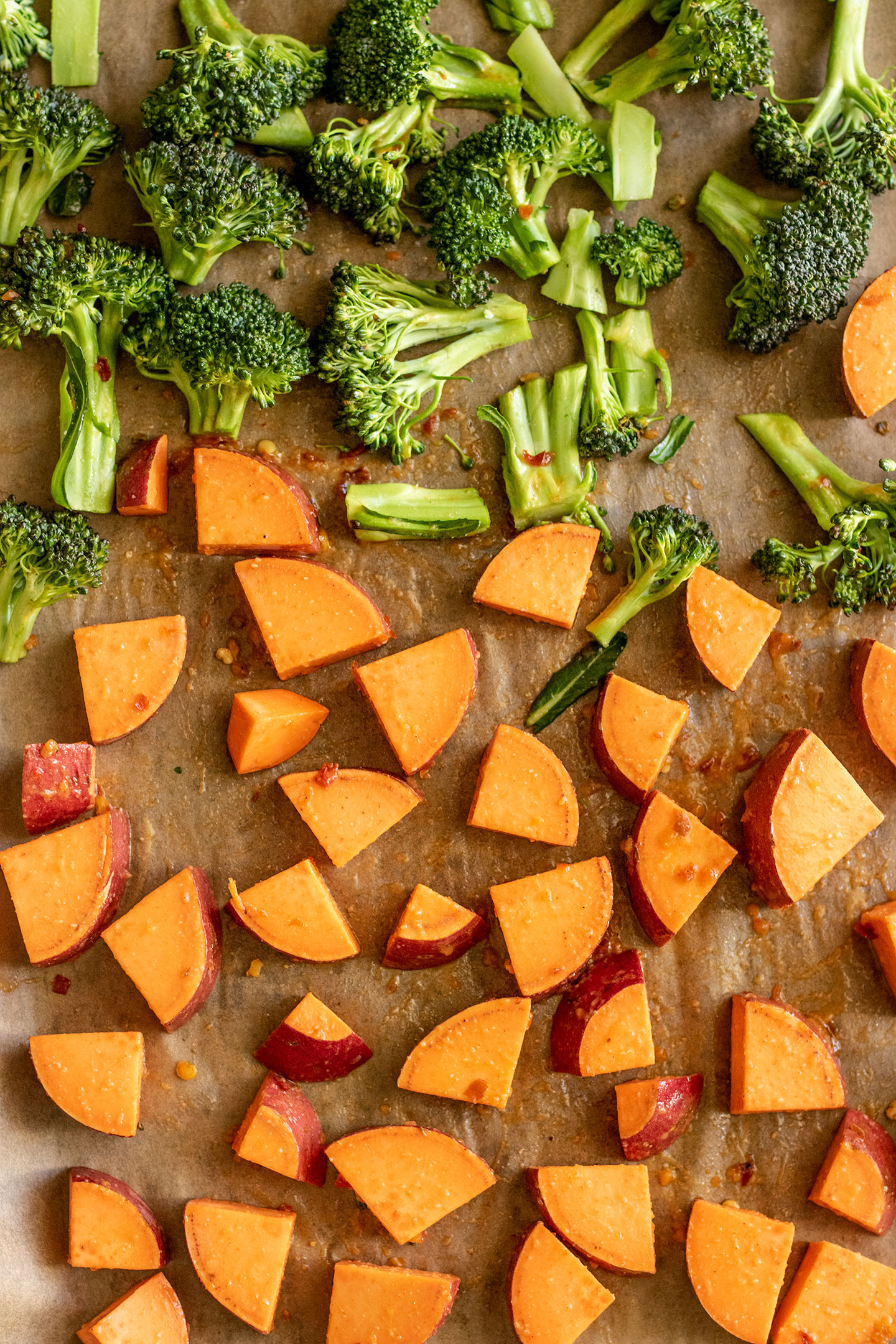 Miso coated potatoes and broccoli on a sheet pan.