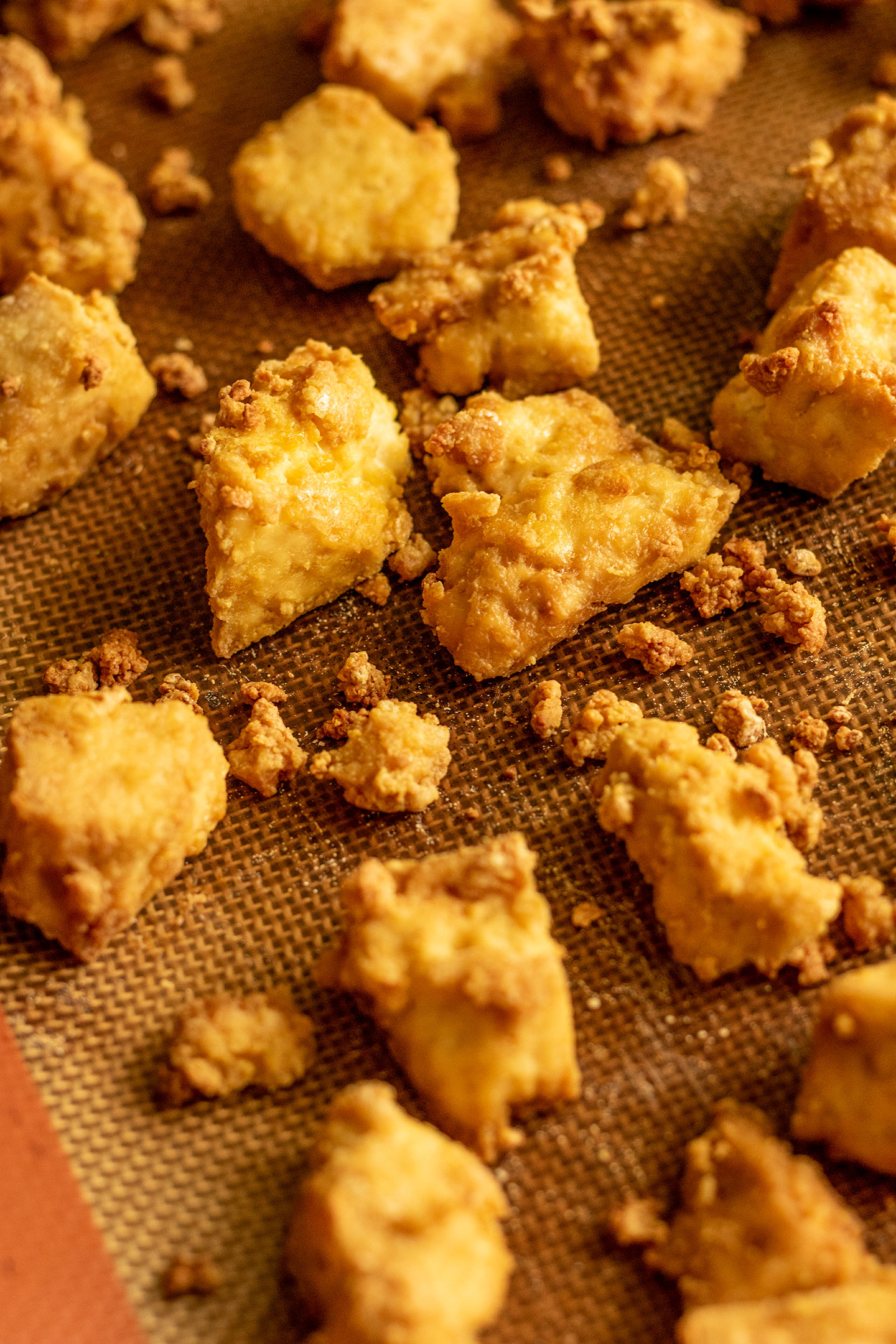 Crispy roasted tofu right out of the oven on a baking tray.