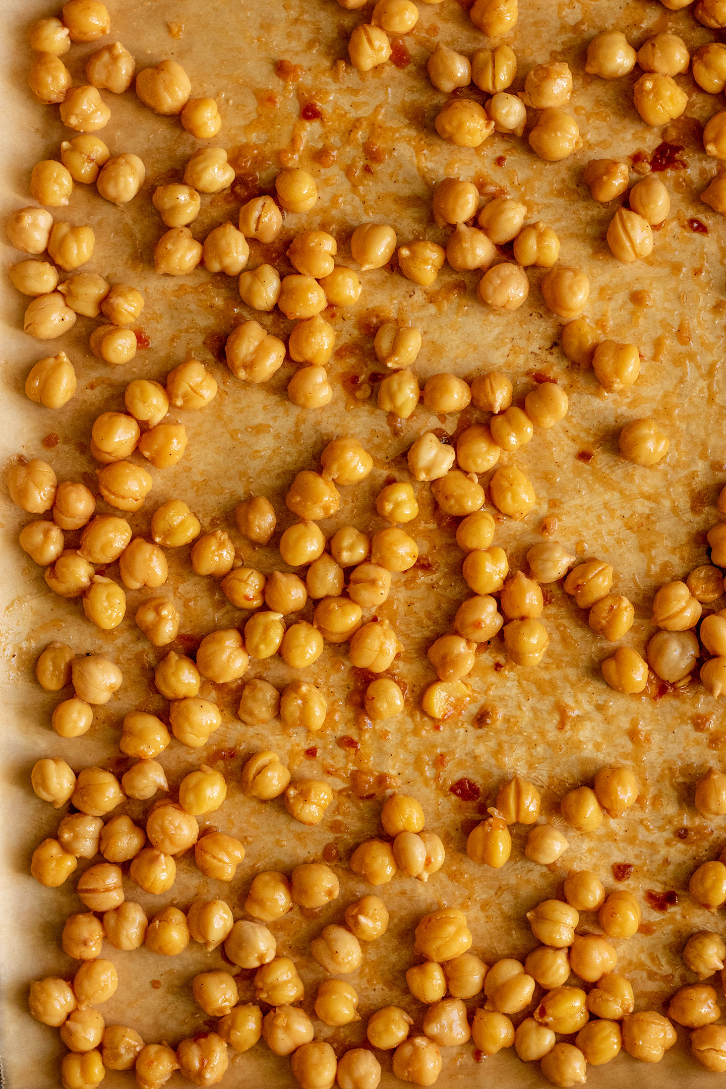 Miso coated chickpeas on a baking tray.