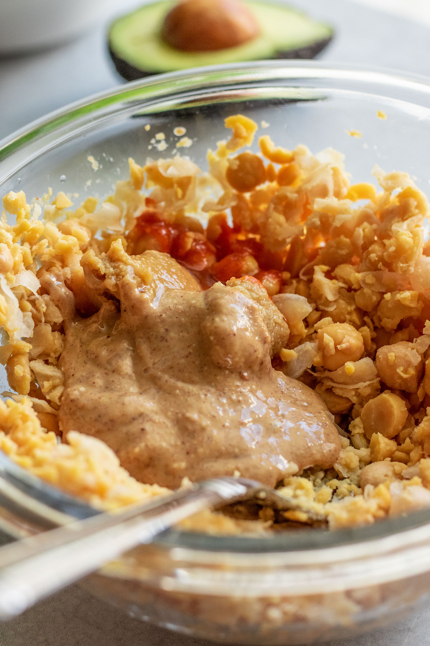 Mashing the chickpeas with peanut butter, sriracha and miso paste.