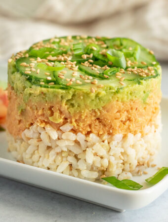 Close up view of the layers seen in the chickpea stack including rice, chickpeas, avocado and cucumbers.
