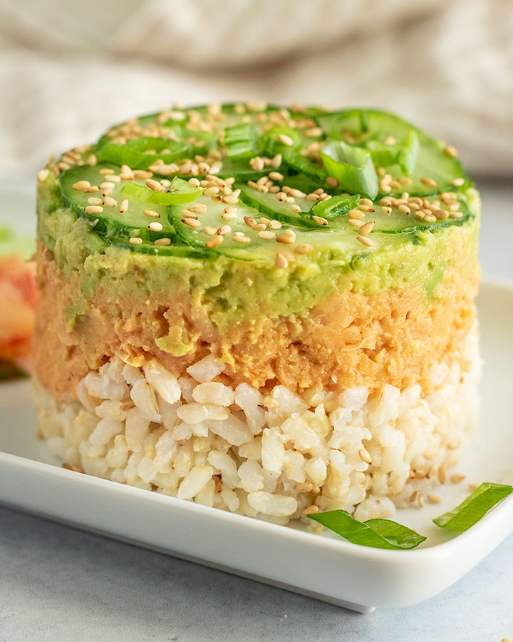 Close up view of the layers seen in the chickpea stack including rice, chickpeas, avocado and cucumbers.