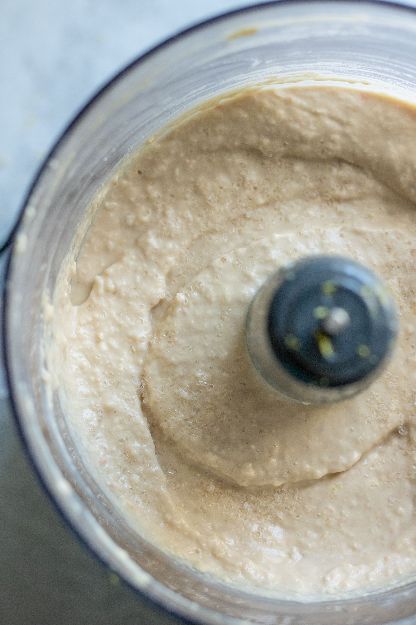 Blending the beans, tahini, lemon, garlic, miso together smooth in a food processor.