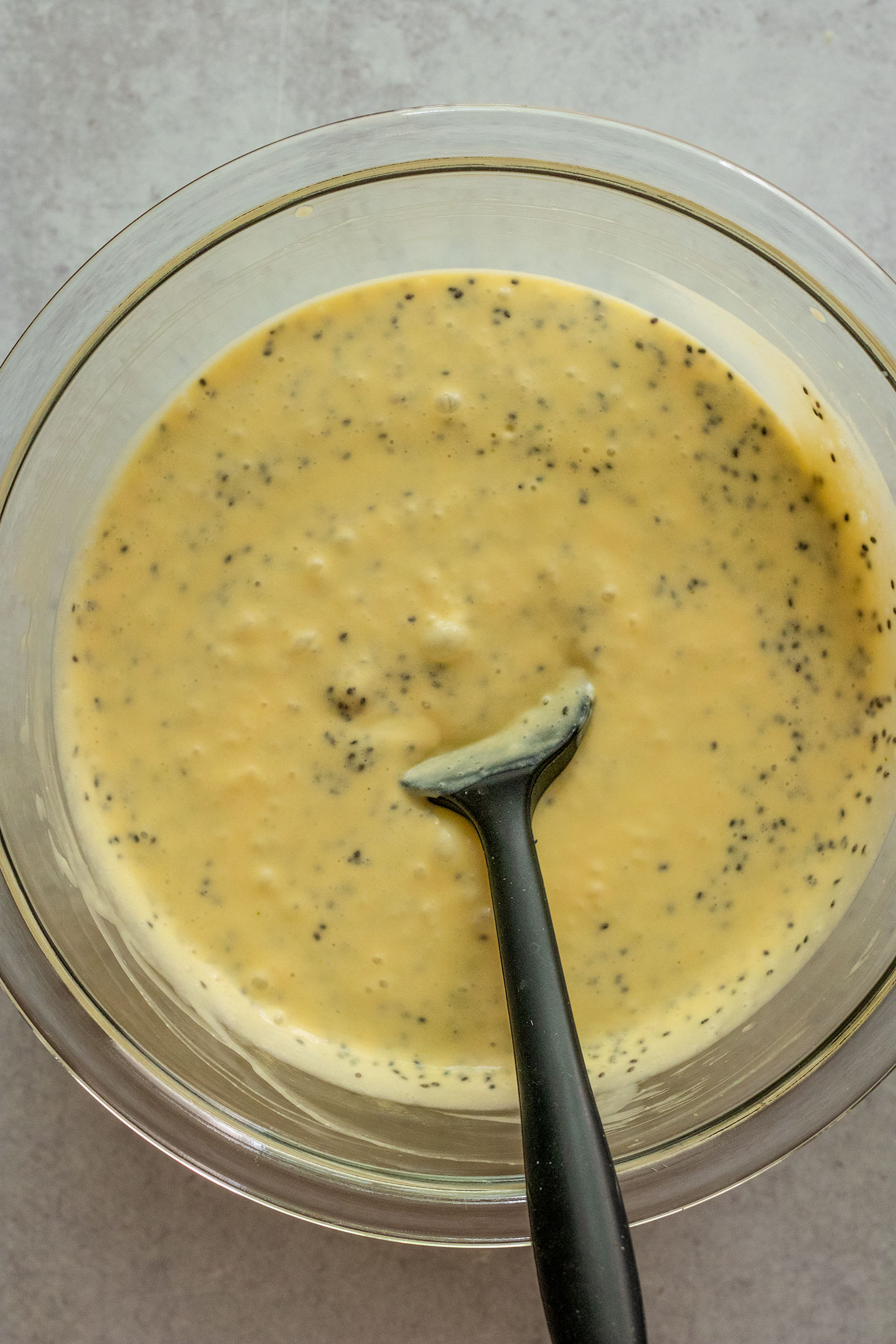 Mixing the chia seeds and mango milk together in a bowl.
