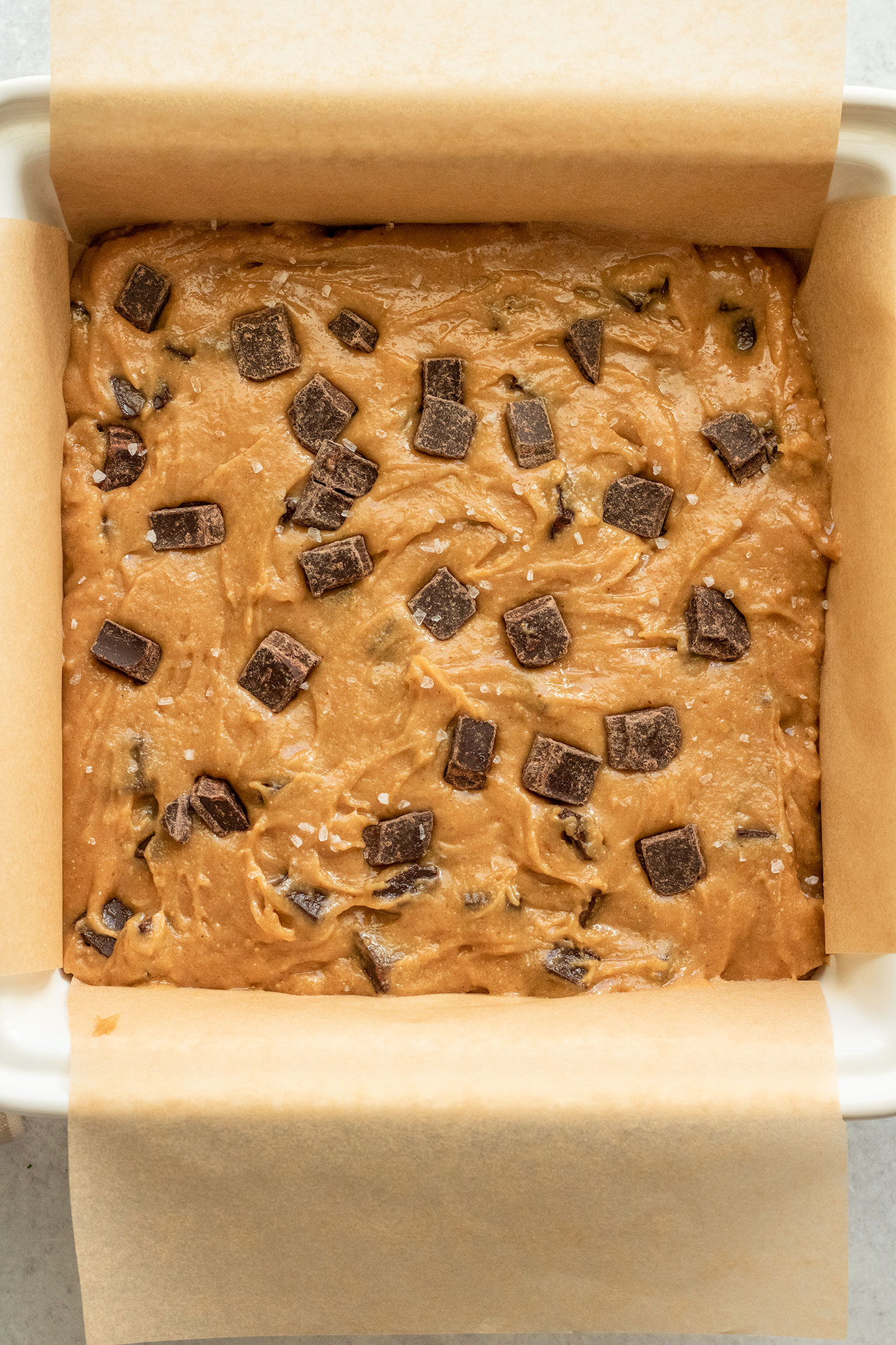 Tray of blondies topped with extra chocolate chips before being placed in the oven.