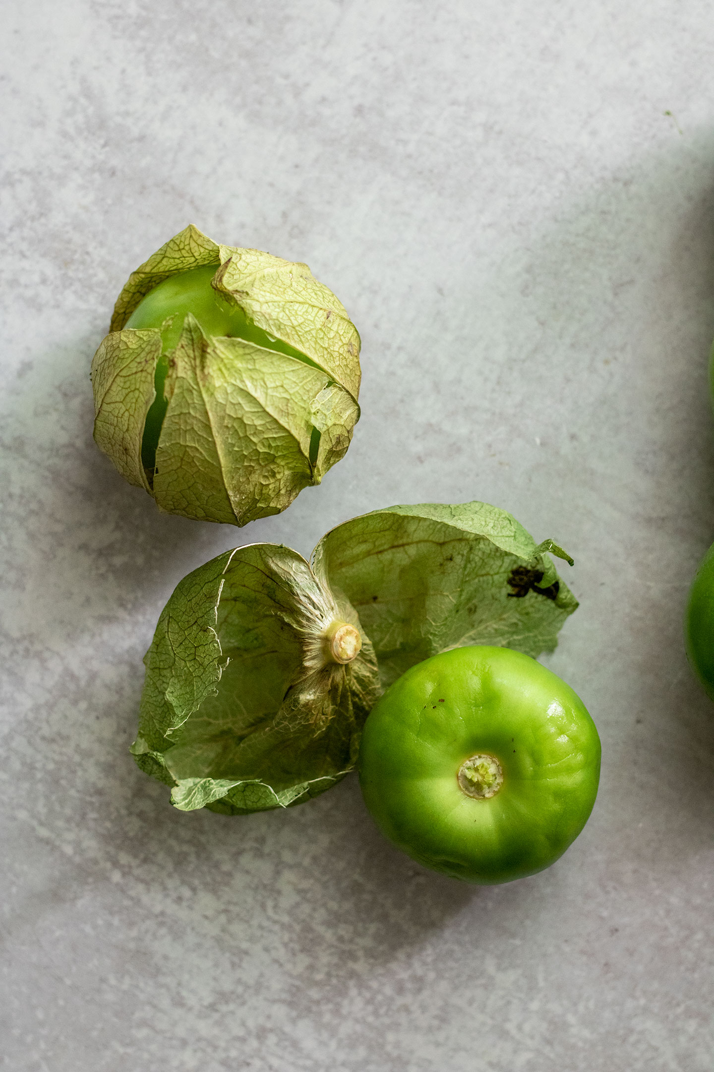 Peeling the husk off of the tomatillos.
