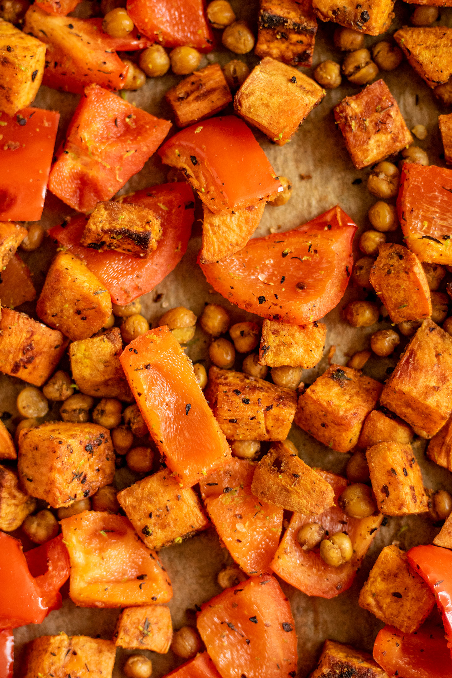 Roasted peppers, chickpeas and sweet potato on a sheet pan.