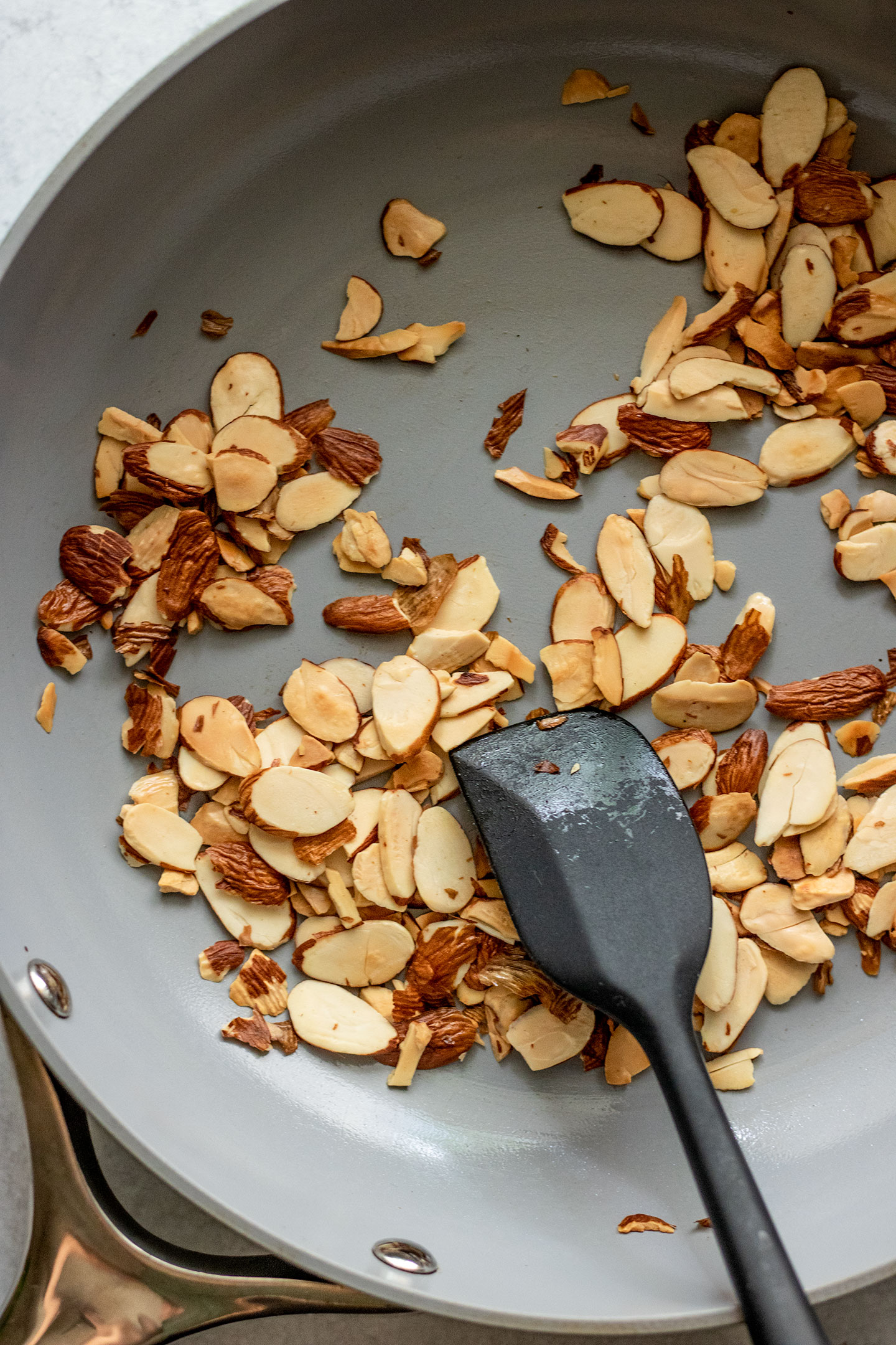Toasting almonds in a pan.