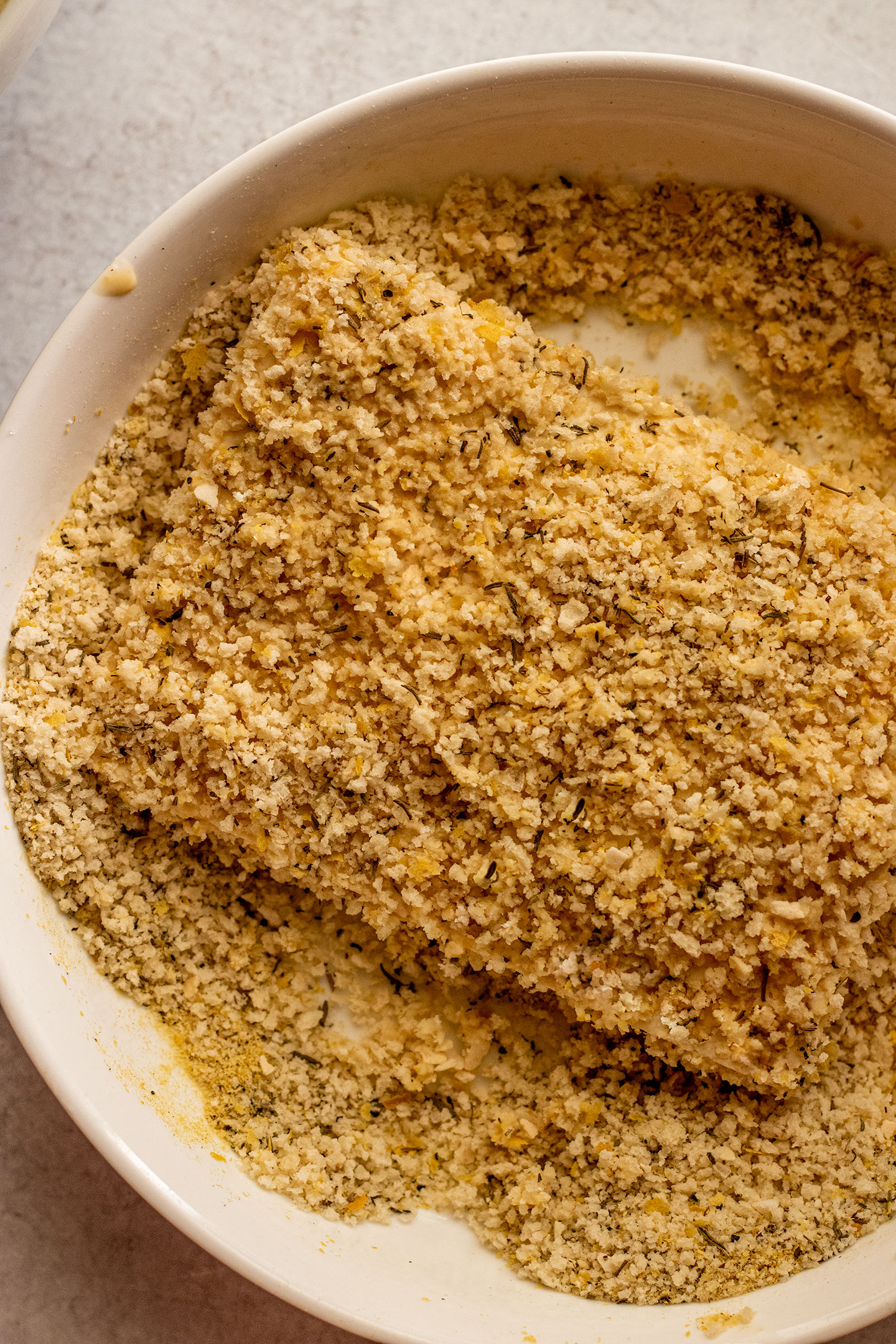 Breading the tofu cutlets in the panko bread crumb mixture.