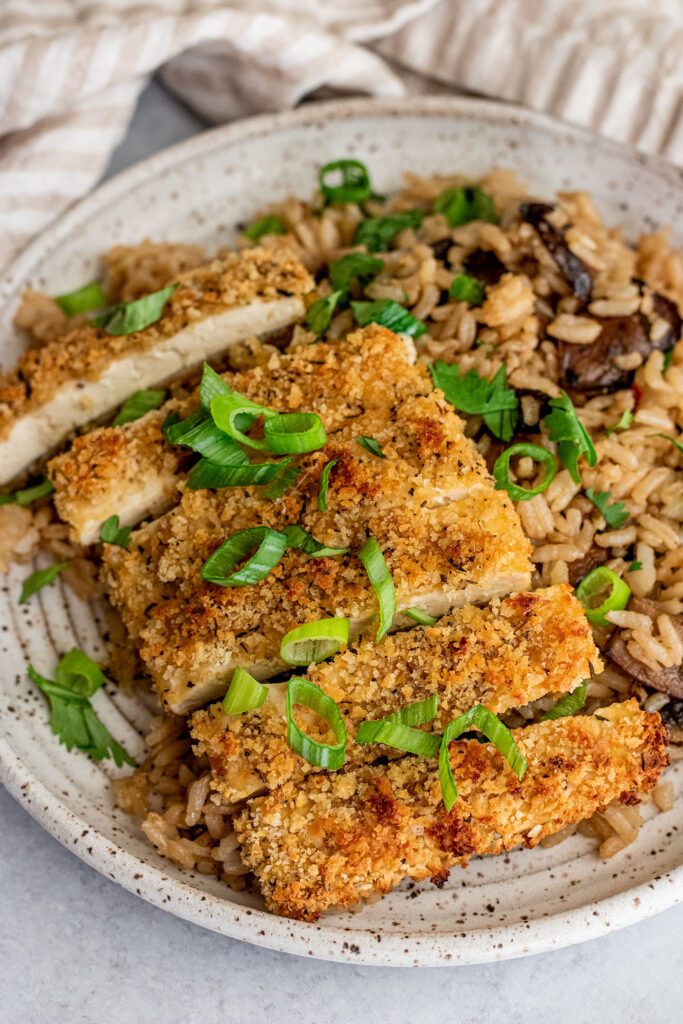 Crispy tofu cut into strips and placed over fried rice.