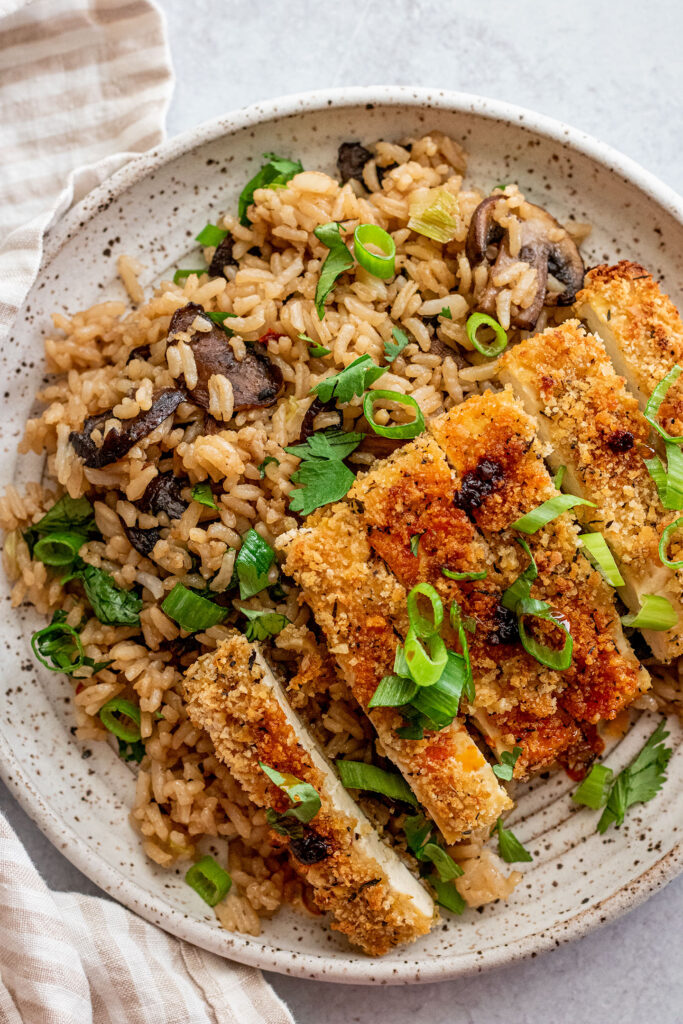 Fried rice topped with sliced panko crusted tofu and topped with extra scallions.