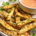 Zucchini fries plated with ketchup mayo sauce.