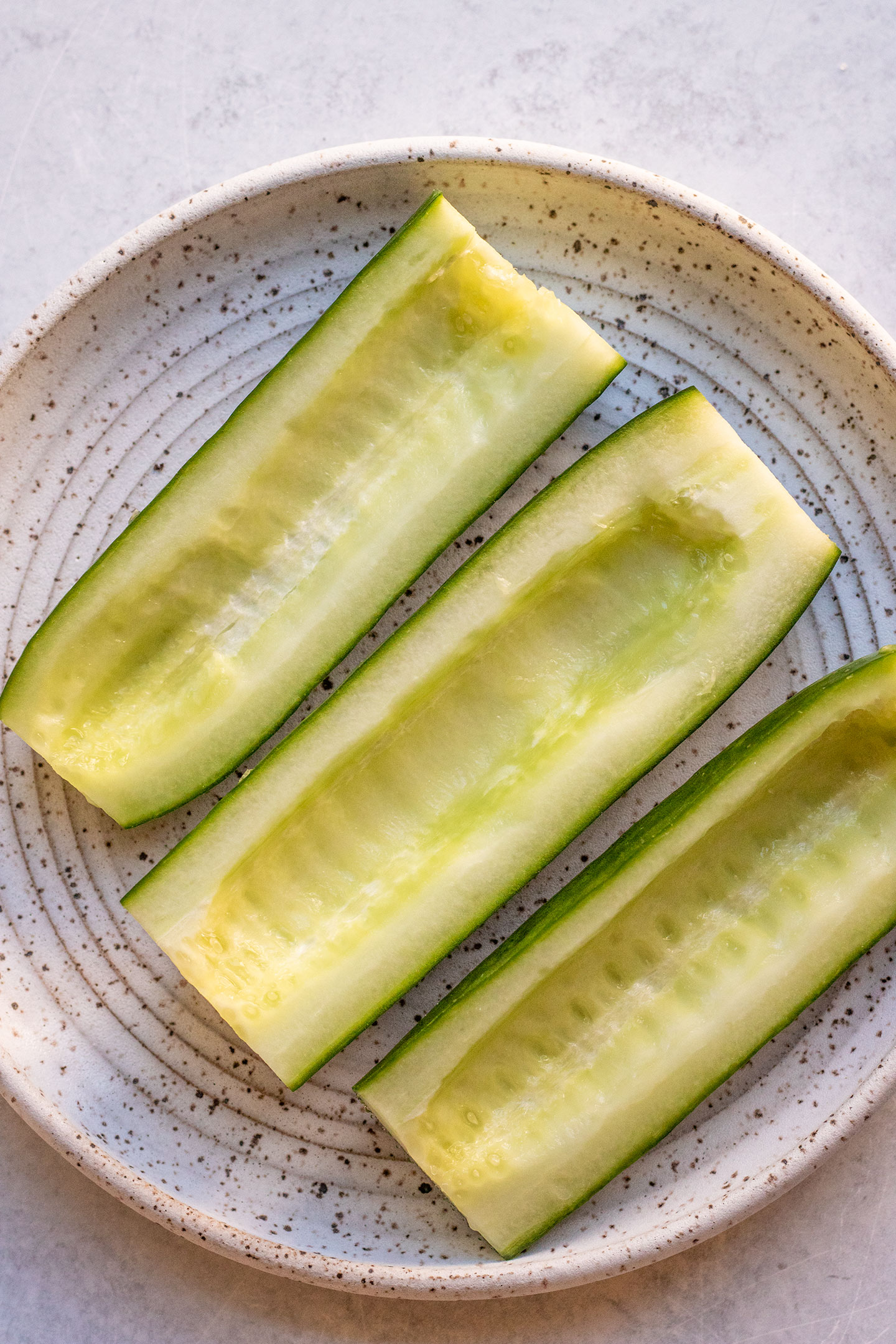 Deseeded cucumbers on a plate.