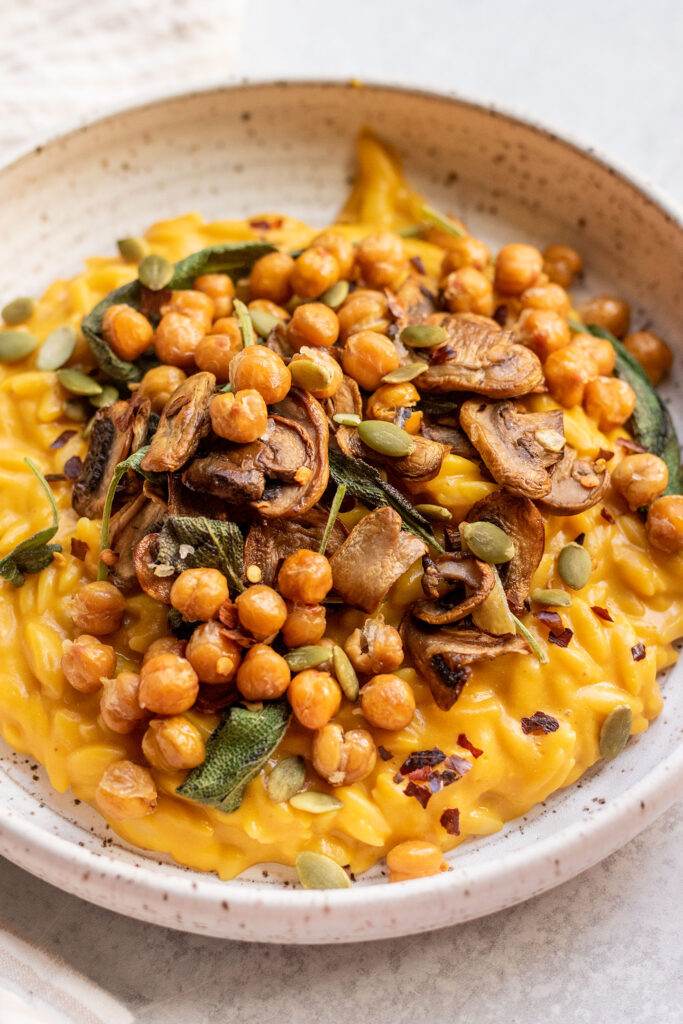 Orzo mixed with a butternut squash sauce with mushrooms and crispy chickpeas.