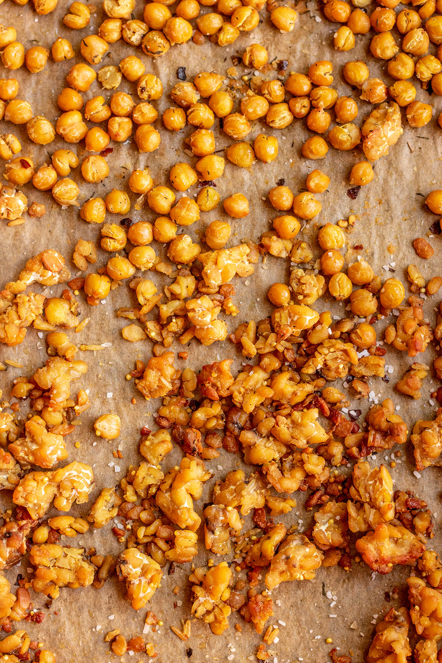Chickpeas and crumbled tempeh after roasting in the oven, nicely browned and crispy.
