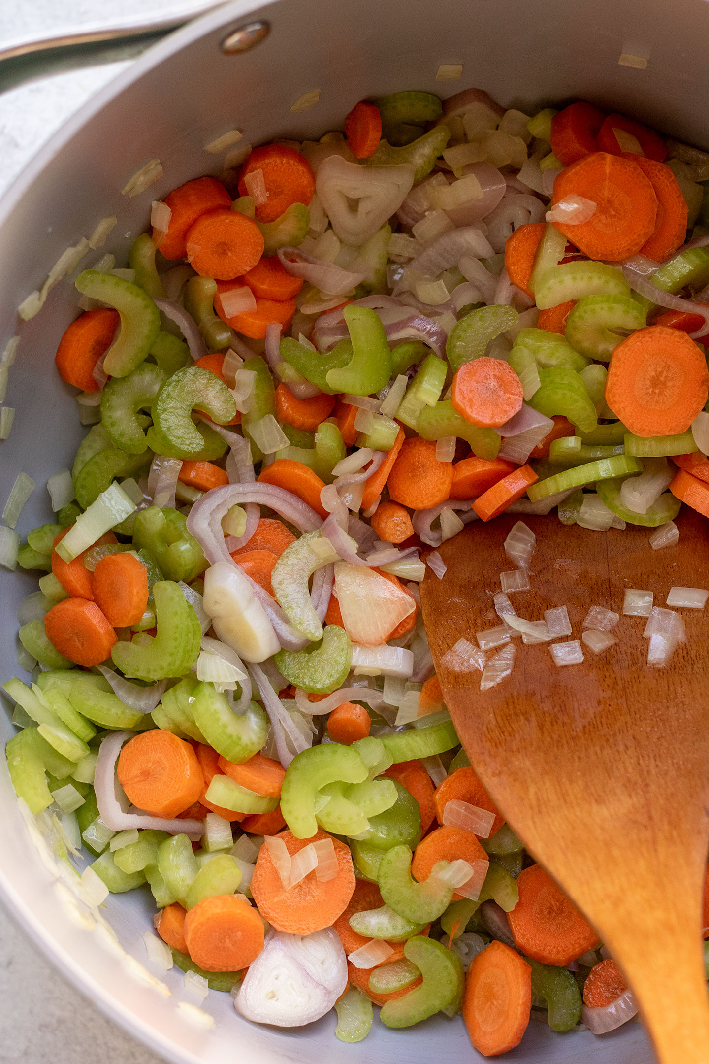 Sauteing the carrots, celery and onions together in a large pot.