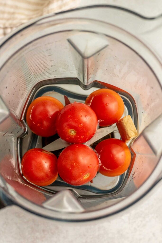 Tomatoes, water and bouillon cube in a blender cup.