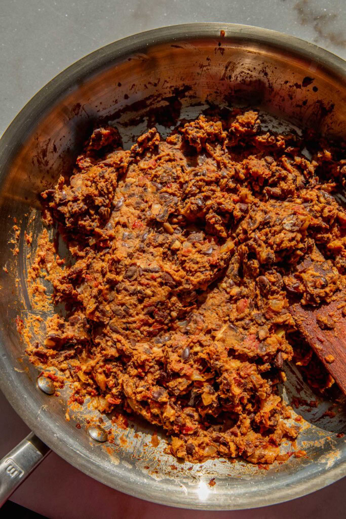 Mashed black bean taco filling in a pan.