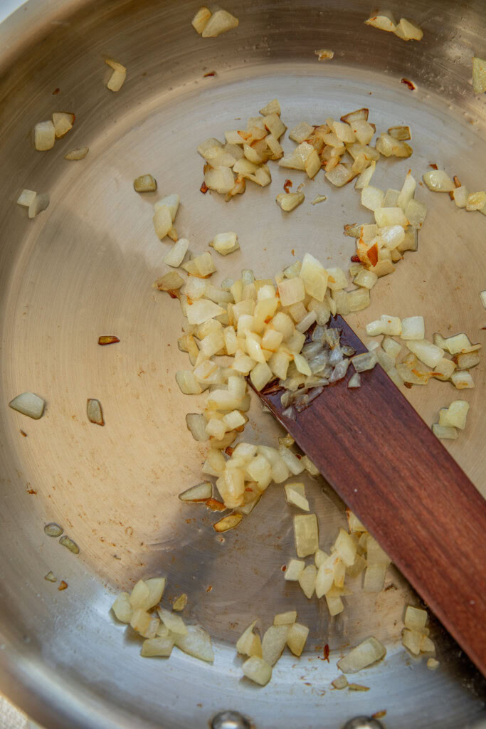 Sauteing onions until brown.