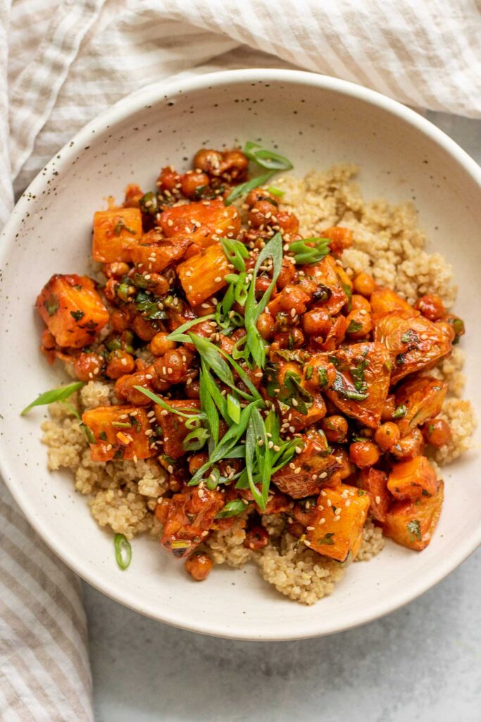Gochujang coated potatoes and chickpeas over a bed of quinoa and topped with scallions.