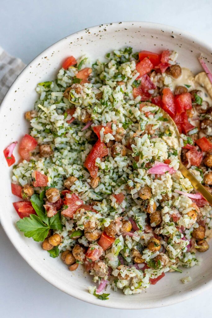 Mixed green herby rice, with tomatoes, chickpeas, pickled onions and hummus dressing.