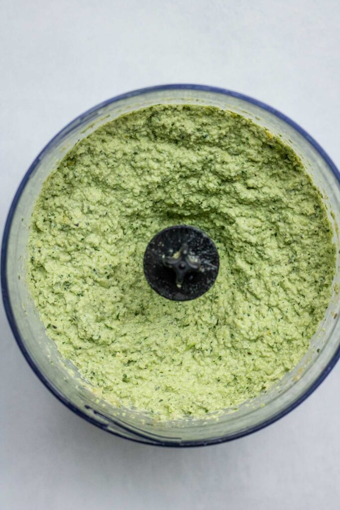 Blended edamame and herbs in a blender cup.