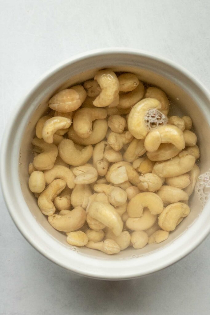 Adding water to soak raw cashews.