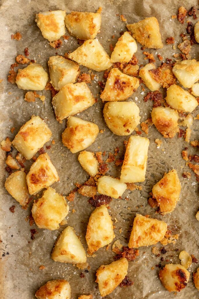 Crispy roasted potatoes on a sheet pan.