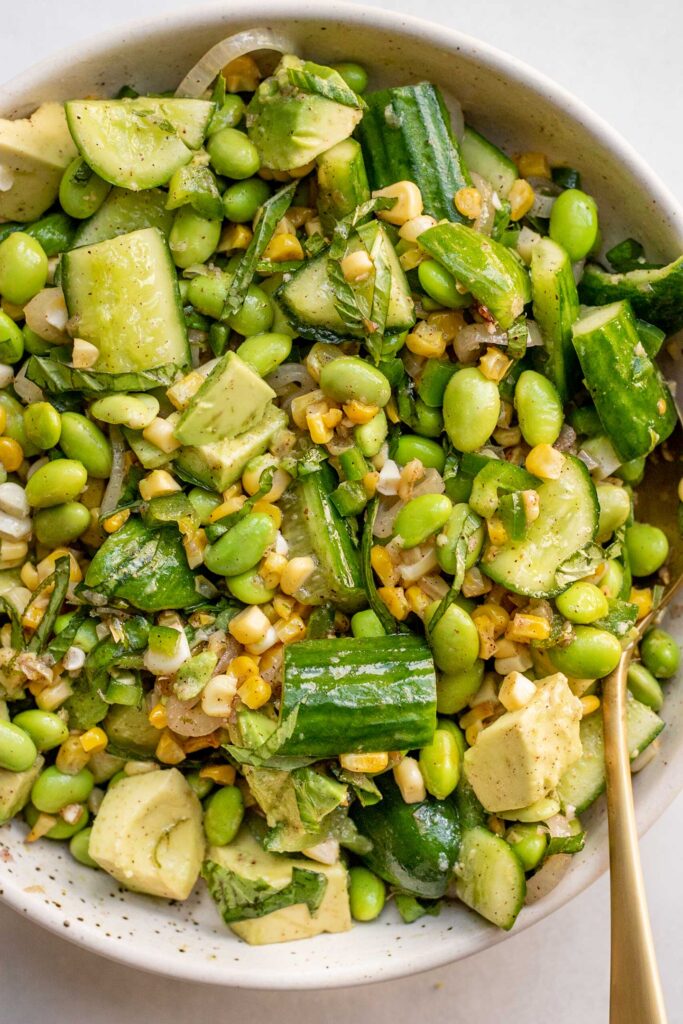 Combining all the corn and edamame ingredients together in a bowl to combine.