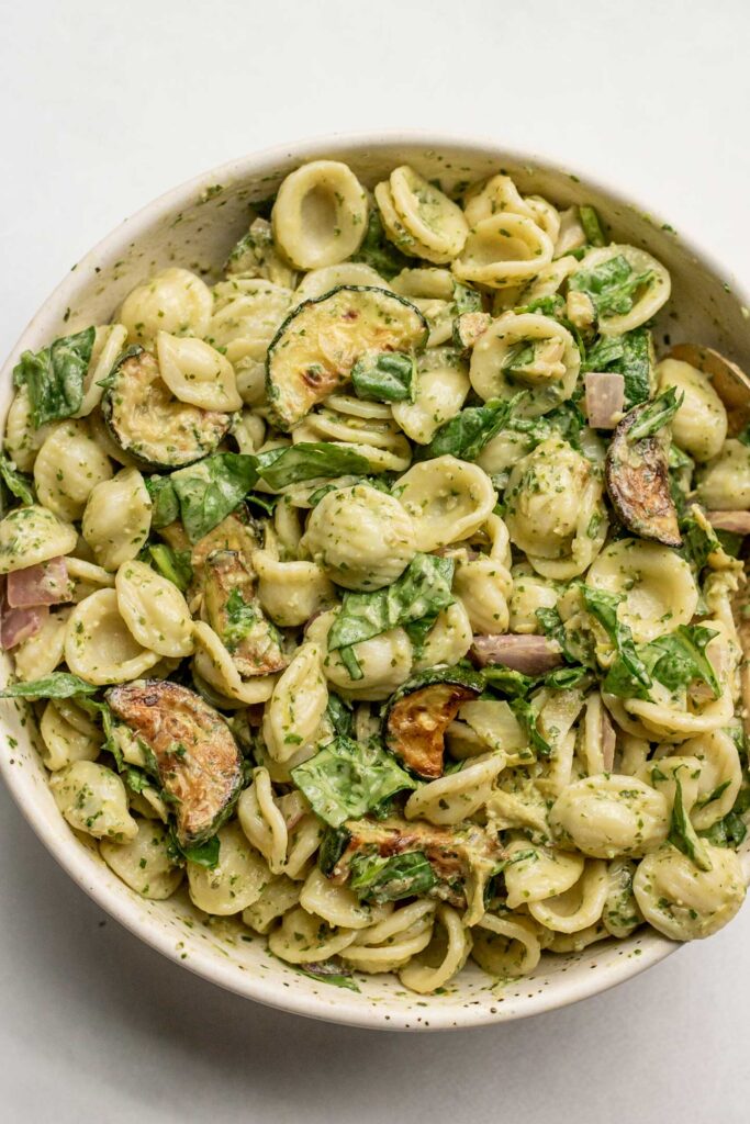 Large bowl of mixed pasta tossed with lemon basil sauce.