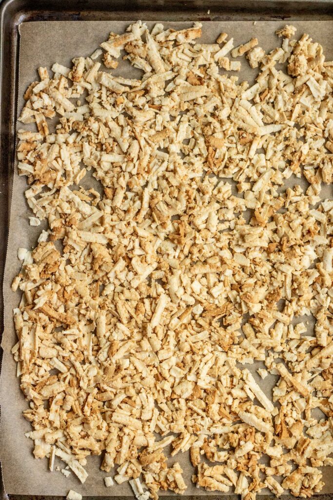 Seasoned tofu shreds on a baking tray.