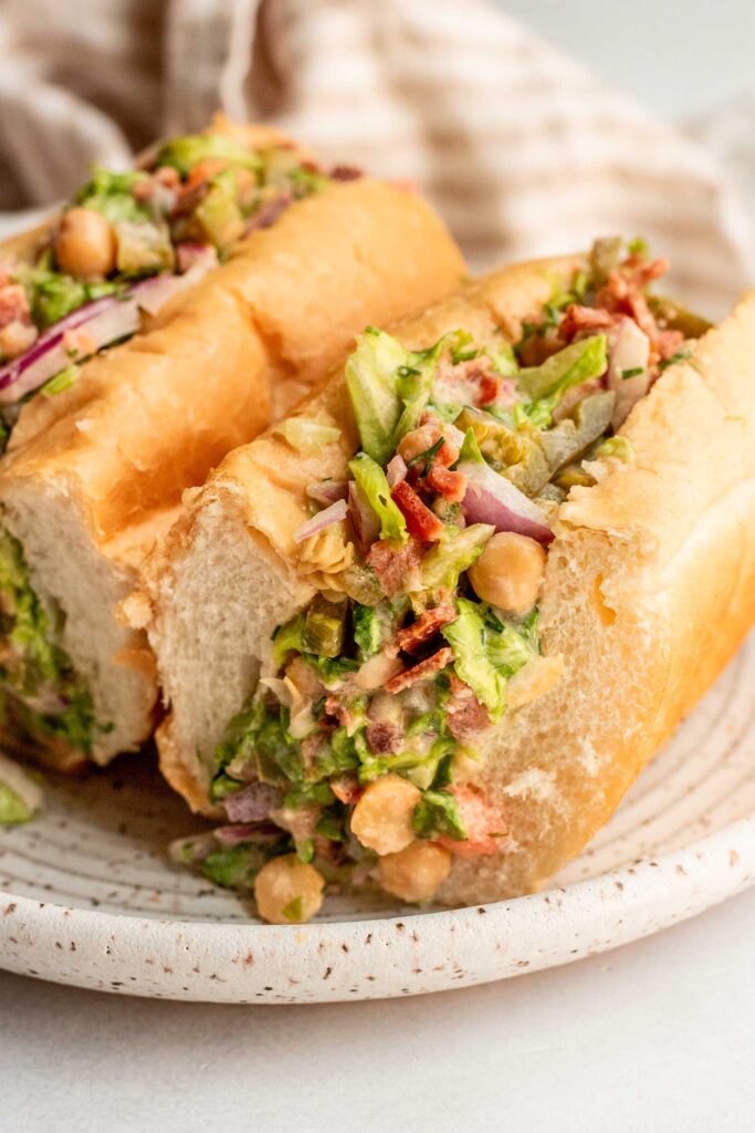 Stuffed chopped vegetable roll cut in half on a plate.