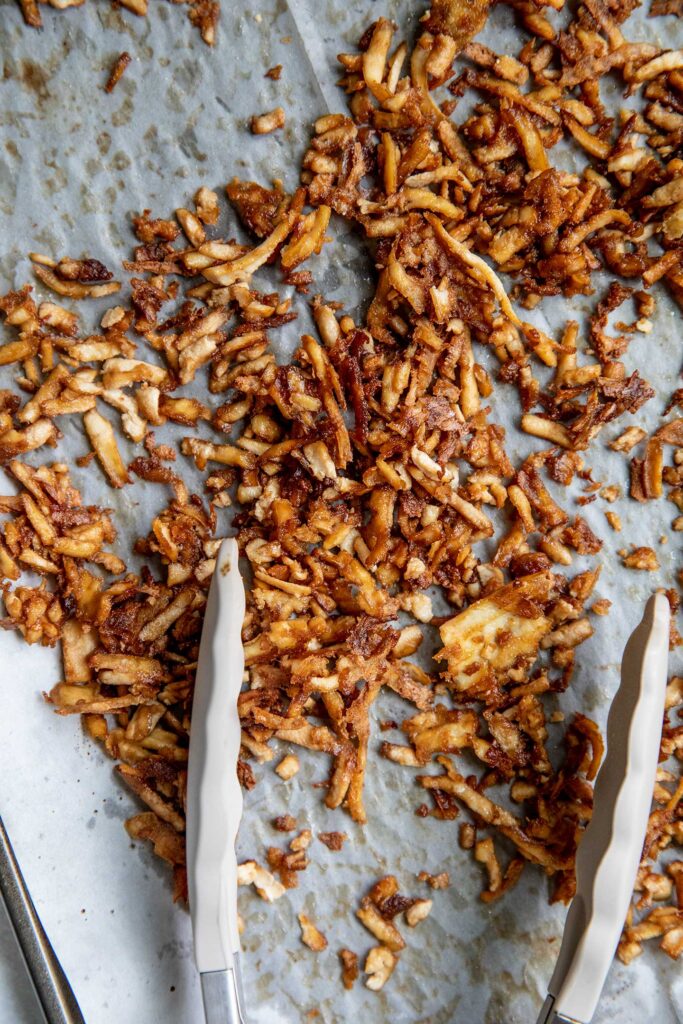 Baked shredded seasoned tofu on a baking tray.