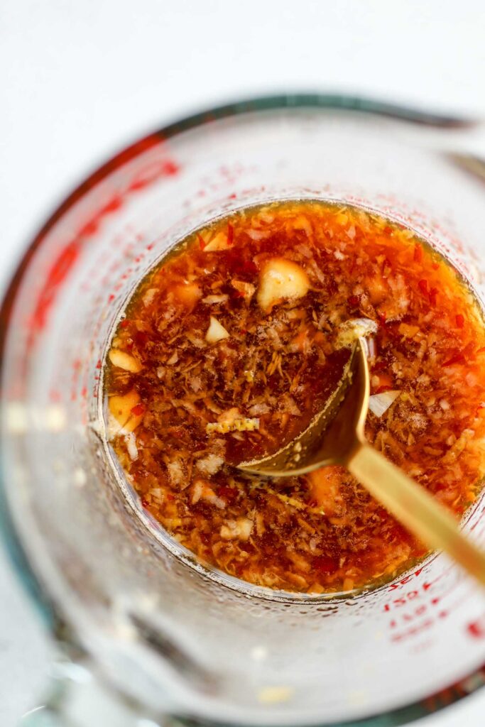 Mixing the lemon sauce together in a large measuring cup with a spoon.