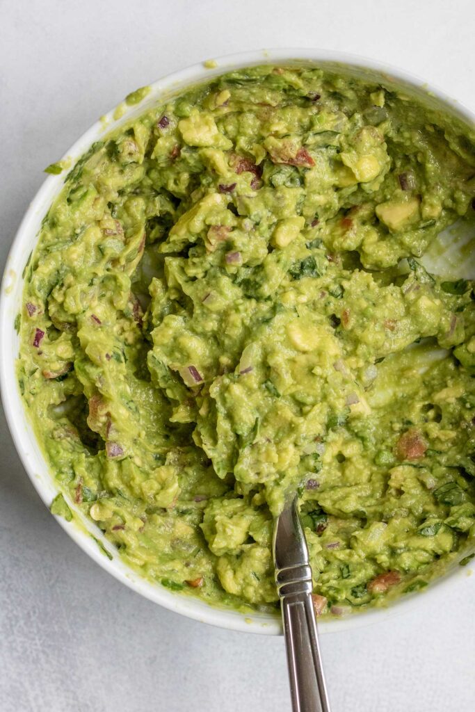 Freshly mashed guacamole in a bowl.