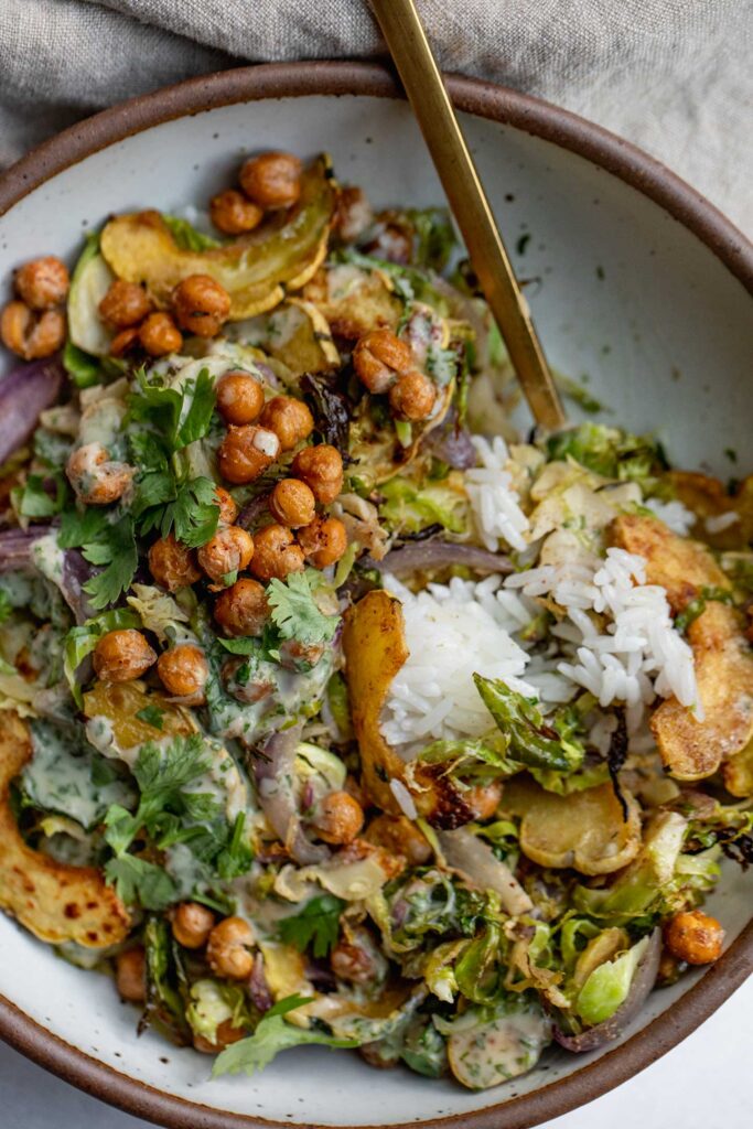 Grabbing a spoonful of a crispy shredded brussels sprout salad topped with crispy chickpeas.