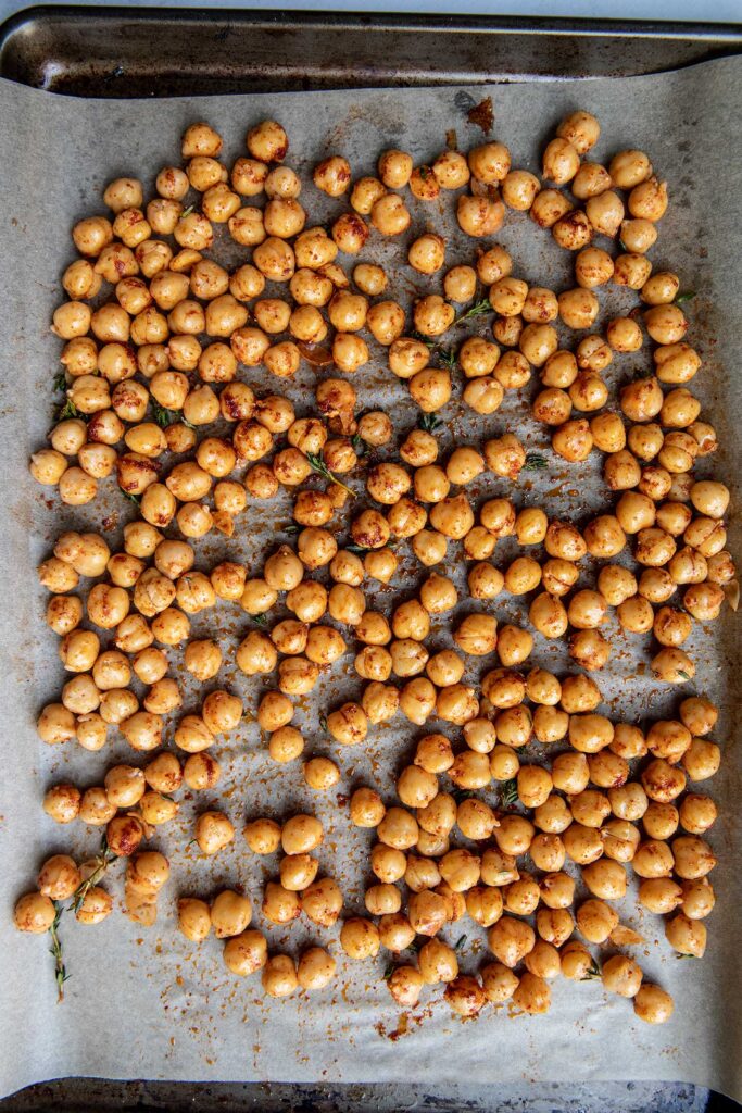 Seasoned chickpeas on a baking tray.