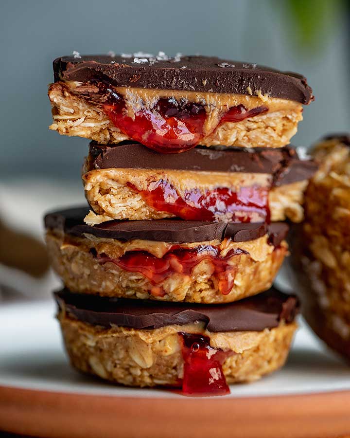 A plate stacked with 4 peanut butter and jelly oatmeal cups.