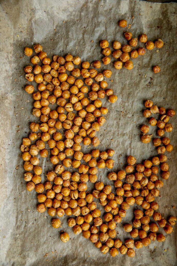 Roasted chickpeas on a baking tray.