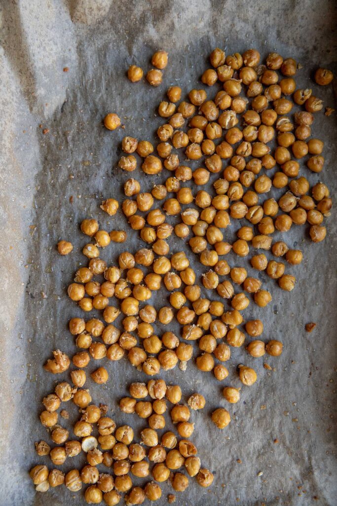 Roasted chickpeas on a baking tray.