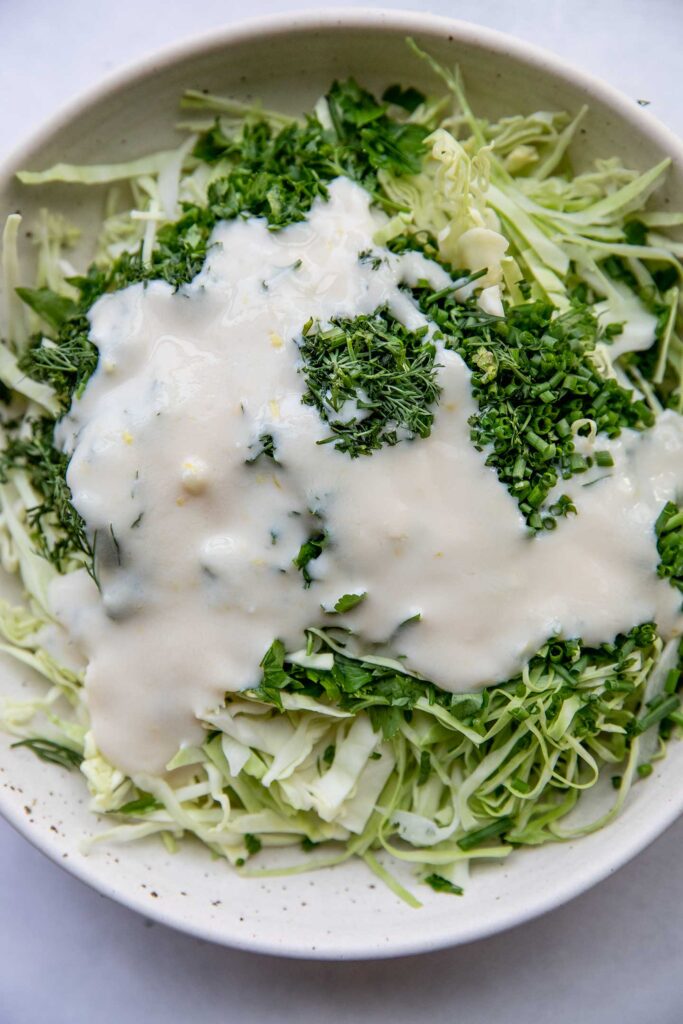Cabbage and herbs topped with lemon yogurt sauce.