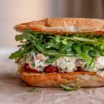 Sandwich stuffed with roasted red pepper, spinach artichoke white beans, arugula and pesto.