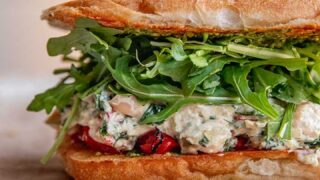 Sandwich stuffed with roasted red pepper, spinach artichoke white beans, arugula and pesto.