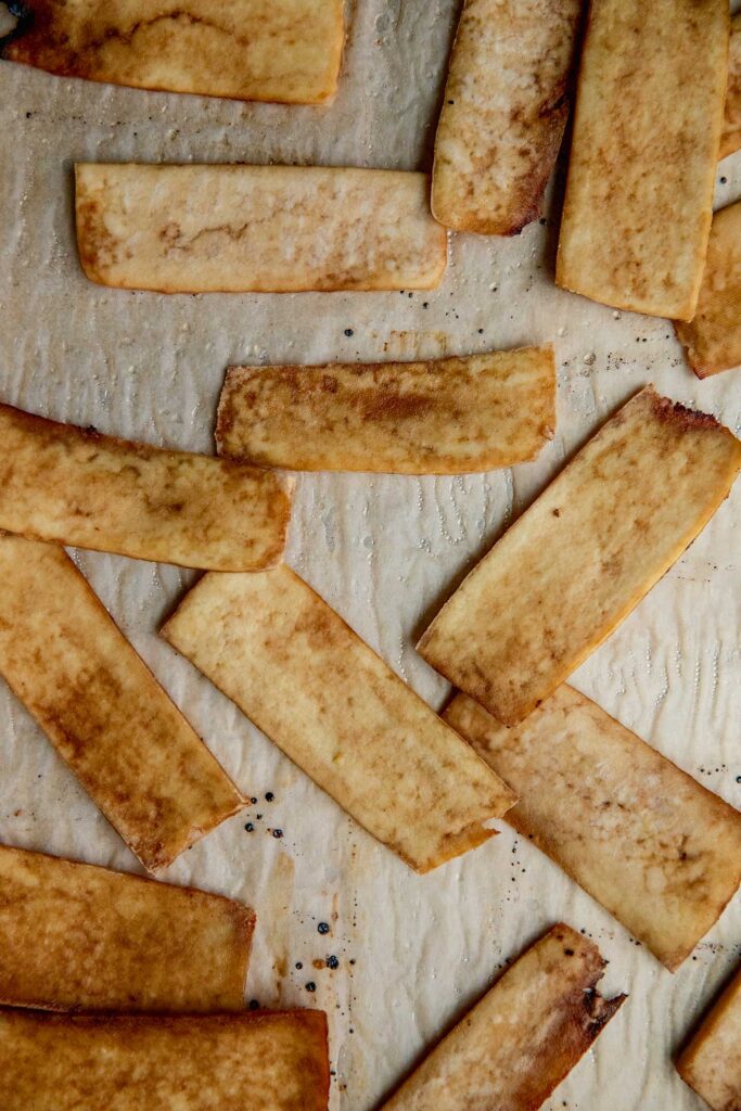 Baked tofu strips on a tray.